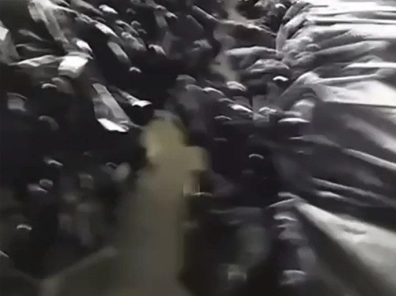 Video still showing hundreds of paratroopers in black plastic bags.