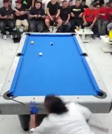 Video still of a pool tournament interrupted by gunfire.
