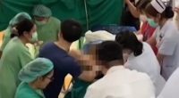 Medical personnel assisting with a hospital birth during an earthquake.