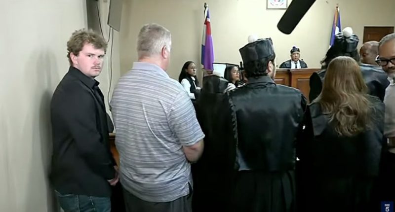 A man enters a Dominican courtroom as his lawyers argue his illegal detainment.