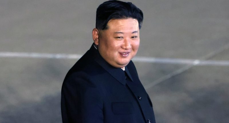 Kim Jong Un smiling at a departure ceremony.