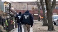 ICE agents walking down a city street.