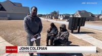 John Coleman, homeowner's son, speaks with his parents in front of their home.