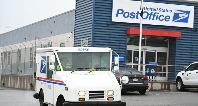 USPS mail truck leaving a post office.
