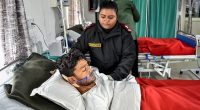 An avalanche survivor on oxygen in a hospital bed.