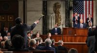 A congressman holds up a cane while President Trump addresses a joint session of Congress.