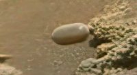 Mars surface with Tic Tac-shaped object.