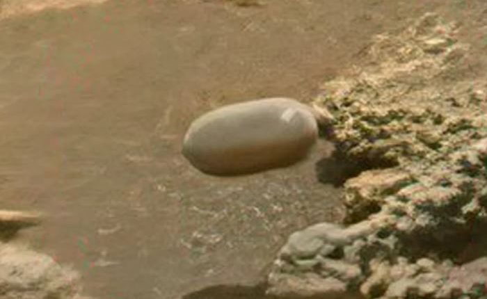 Mars surface with Tic Tac-shaped object.