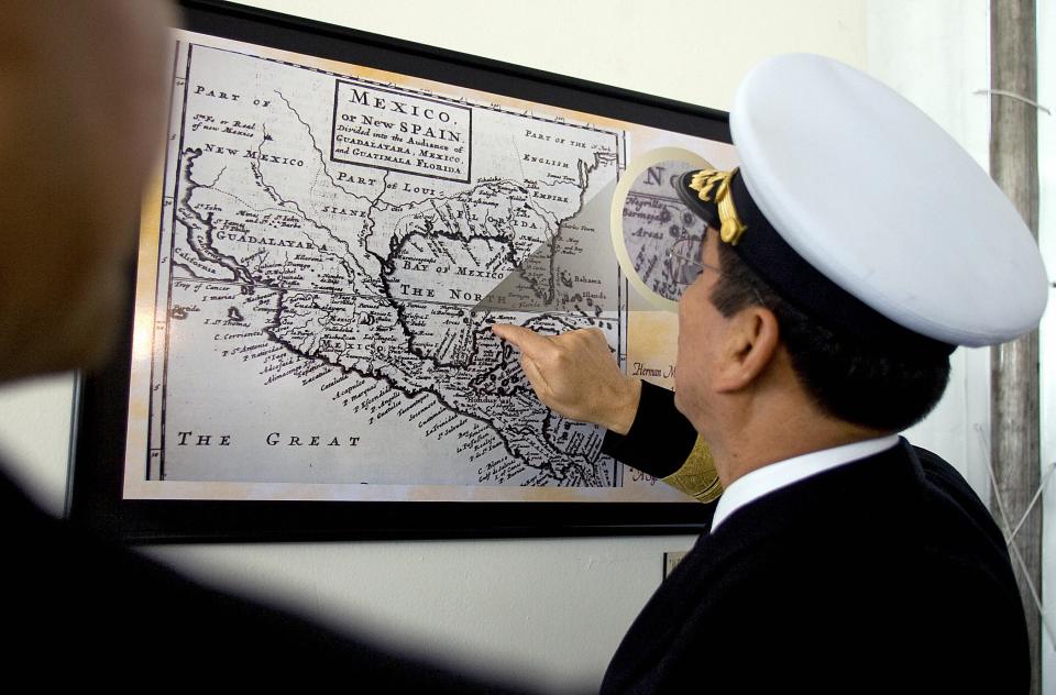A Mexican navy officer points to Bermeja Island on a historical map of Mexico.