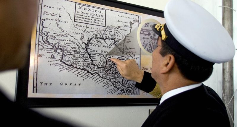A Mexican navy officer points to Bermeja Island on a historical map of Mexico.