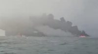 Oil tanker bursts into flames after being struck by container ship