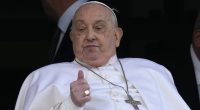 Pope Francis appears on his hospital balcony before he is discharged