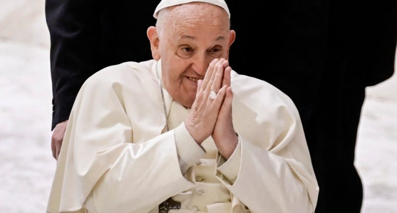 Pope Francis with hands clasped.