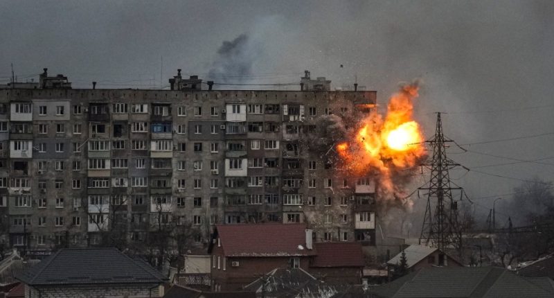 Explosion damaging an apartment building in Mariupol, Ukraine.
