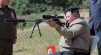 Kim Jong Un aiming a rifle at a North Korean army training base.