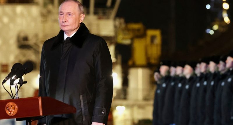 Vladimir Putin speaking at a podium.
