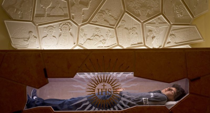Tomb of Blessed Carlo Acutis with bas-reliefs depicting his life and faith.