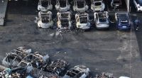 Burned-out Tesla cars at a dealership.