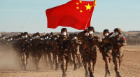 Chinese soldiers marching with their flag.