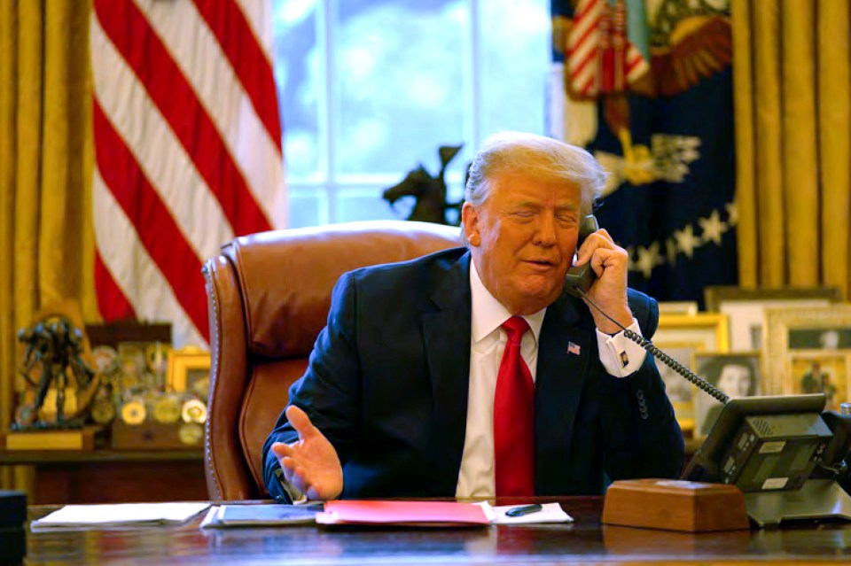 President Trump on the phone in the Oval Office.