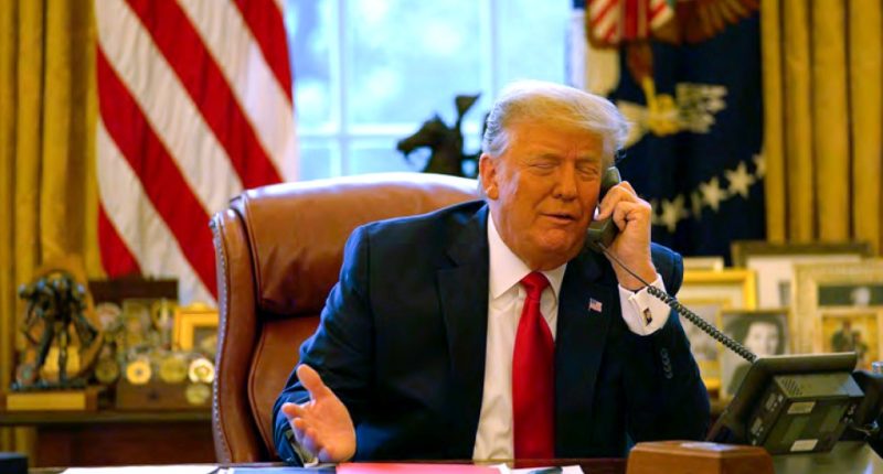 President Trump on the phone in the Oval Office.