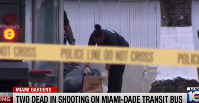Crime scene investigators at the site of a shooting on a Miami-Dade Transit bus where two passengers died.