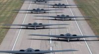 Line of B-2 stealth bombers on a runway.