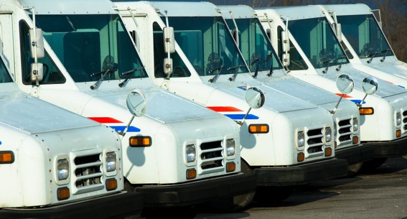 Line of postal delivery trucks.