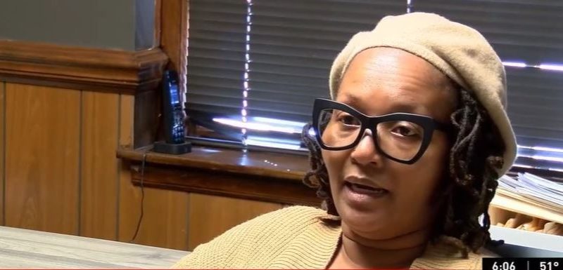 Woman expressing frustration over post office changes in Clio.