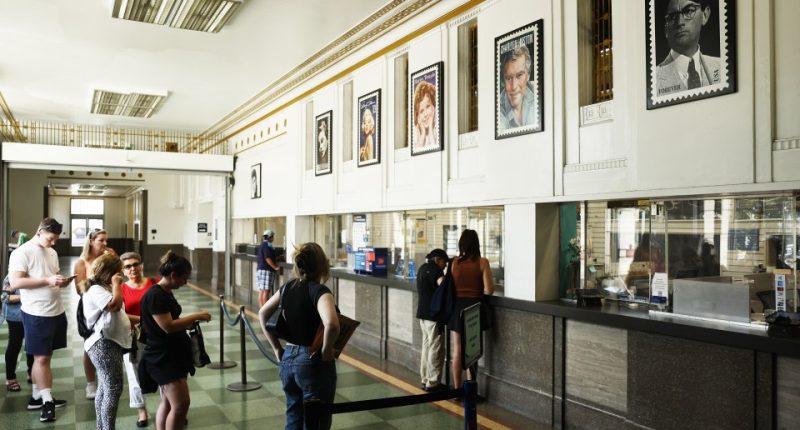 Customers waiting in line at a post office.
