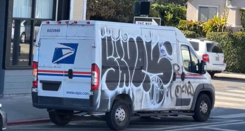 Graffiti-covered USPS mail truck.