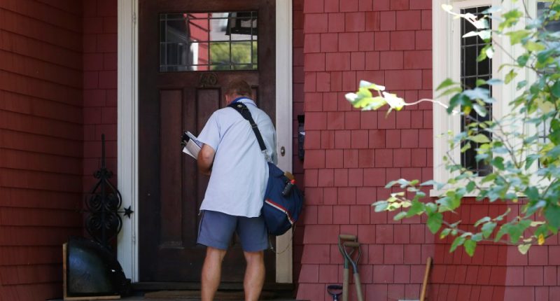 Postal worker delivering mail.