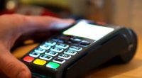 Close-up of a hand using a card reader.