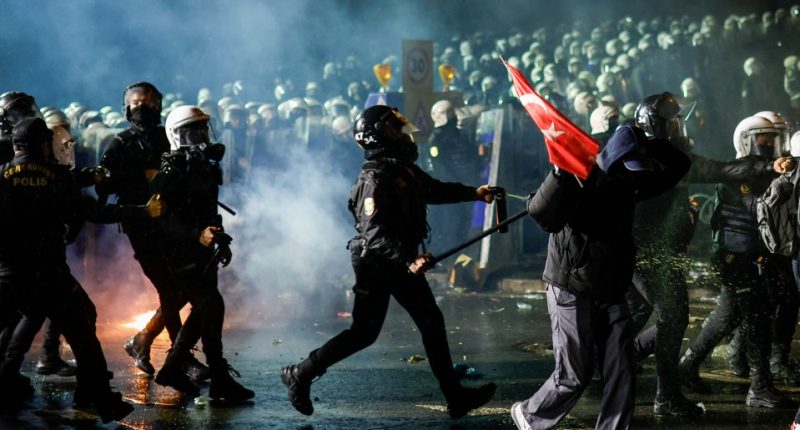 Riot police using pepper spray against protesters in Istanbul.