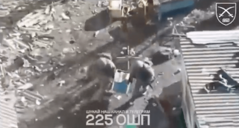 Screenshot of soldiers amidst rubble.