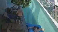 Security camera footage of a couple nearly swept off a rooftop pool float during an earthquake.