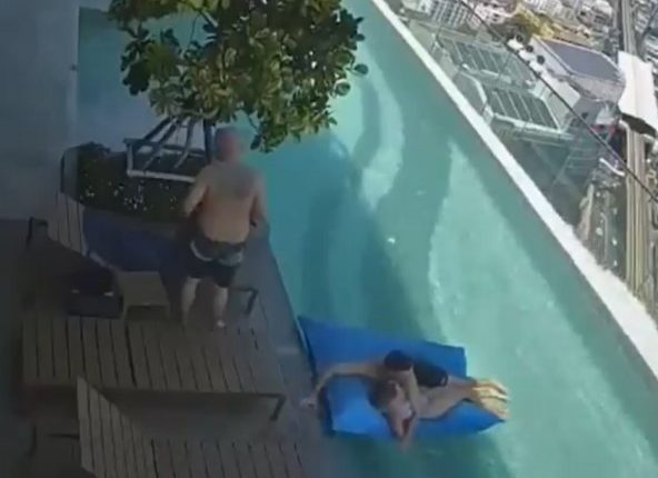 Security camera footage of a couple nearly swept off a rooftop pool float during an earthquake.