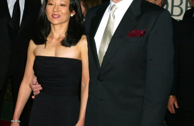 A man and woman in formal wear, arm in arm.