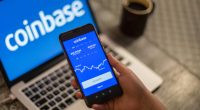 Photo illustration of a person using the Coinbase app on their smartphone.