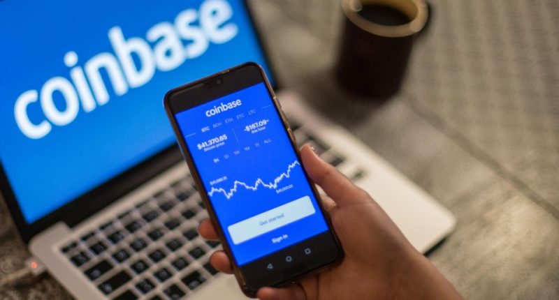 Photo illustration of a person using the Coinbase app on their smartphone.
