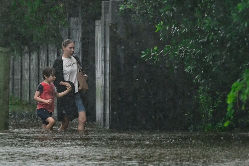 Ex-Tropical Cyclone Alfred dumping deluge as it moves inland, weakens