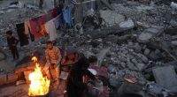 Members of Palestinian Marouf family cook outside their destroyed house by the Israeli army's air and ground offensive in Jabaliya, Gaza Strip.