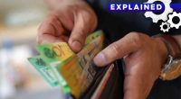 A man taking cash out of his wallet.