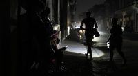 Residents walk on a street during a general blackout in Havana, Cuba, Friday, March 14, 2025