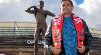 Former St Kilda Saints player and Western Australian-born Noongar man Nicky Winmar poses for a photograph in front of his statue at Optus Stadium in Perth, Saturday, July 6, 2019.