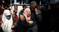 Mourners react next to the bodies of Palestinians killed in an Israeli strike in the northern Gaza Strip on March 15.
