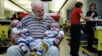 Portrait of James Harrison 72 (2nd from left) with twin boys Seth Murray O+ (left) and Ethan Murray  O-(3rd from left) in the Apheresis department at the Australian Red Cross Blood Service. Hundreds of thousands of babies owe their health and in some cases their life to James Harrison as his blood has been used in every dose of anti-D serum since 1967, which is given when the blood types of mothers and babies are incompatible. Red Cross, Sydney, NSW. Today 20th of May, 2009. Photo by KATE GERAGH