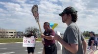Protesters at Orlando Tesla dealership decry Musk, DOGE