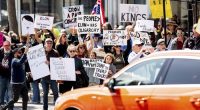 Protesters rally against Tesla CEO Elon Musk outside a Tesla store in San Francisco on Saturday