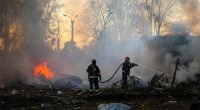 Firefighters put out the fire following a Russian rocket attack in Kharkiv, Ukraine.